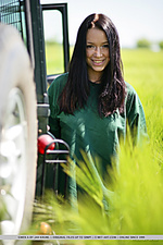 Gwen playfully strips her green shirt matching the green grassy field and poses naughtily all over the jeep, flaunting her awesome physique and gorgeous breasts.