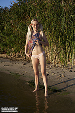 Blonde babe by the sea